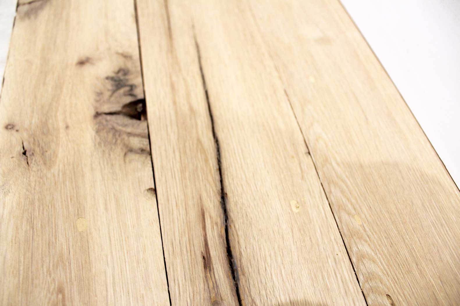reclaimed white oak flooring installed. Variations in wood color shown along with knots and checking.