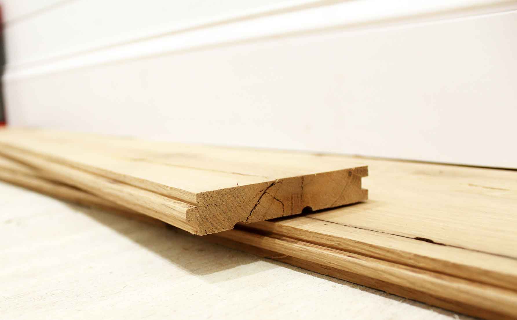 close up of reclaimed white oak flooring end. Square edges and tongue and groove shown.