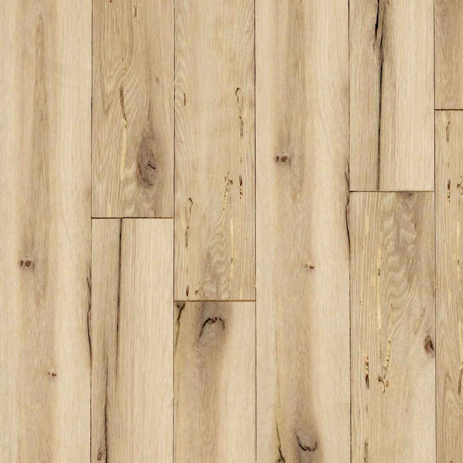 close up of reclaimed white oak flooring installed. Variations in wood color shown along with knots, checking, and characteristics from previous bug activity.